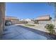 A concrete patio and desert landscaping in backyard at 5854 Heather Marie Dr, Las Vegas, NV 89110
