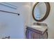 Powder room with granite vanity, mirror, and brushed bronze fixtures at 5854 Heather Marie Dr, Las Vegas, NV 89110