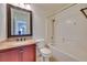 Bathroom featuring granite countertop, wood cabinets, and bathtub at 5854 Heather Marie Dr, Las Vegas, NV 89110
