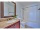A bathroom with a bathtub, shower, granite countertop, and wooden mirror at 5854 Heather Marie Dr, Las Vegas, NV 89110