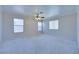 This is a spacious empty bedroom with three windows and a ceiling fan at 5854 Heather Marie Dr, Las Vegas, NV 89110