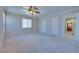 This is a spacious empty bedroom with three windows, a ceiling fan, and carpet floors at 5854 Heather Marie Dr, Las Vegas, NV 89110