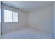 Bright bedroom with a large window and neutral-colored walls and carpet at 5854 Heather Marie Dr, Las Vegas, NV 89110