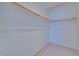 Walk-in closet featuring carpet flooring, white walls, and wooden rods for hanging clothes at 5854 Heather Marie Dr, Las Vegas, NV 89110