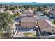 Back exterior of home showing the backyard with gravel, minimal landscaping, and views of the surrounding suburban area at 5854 Heather Marie Dr, Las Vegas, NV 89110