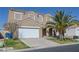 Two-story home featuring a two-car garage, drought resistant landscaping, and desert charm at 5854 Heather Marie Dr, Las Vegas, NV 89110