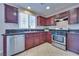 Kitchen featuring cherry cabinets, stainless steel appliances, and tile flooring at 5854 Heather Marie Dr, Las Vegas, NV 89110
