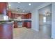 Open kitchen with cherry cabinets, stainless steel appliances, and tile flooring at 5854 Heather Marie Dr, Las Vegas, NV 89110