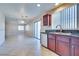Well-lit kitchen with cherry cabinets, stainless steel appliances, and tile floors at 5854 Heather Marie Dr, Las Vegas, NV 89110