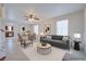Bright living room with modern decor, neutral tones, and an open floor plan to the dining area at 5854 Heather Marie Dr, Las Vegas, NV 89110