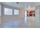 Open-concept living area featuring tile flooring, windows, and a kitchen area at 5854 Heather Marie Dr, Las Vegas, NV 89110