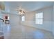 Open living area with neutral paint, tile floors, and natural light from the white blind covered windows at 5854 Heather Marie Dr, Las Vegas, NV 89110