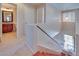 View of a well-lit staircase and upper landing, leading to a bathroom with a wood vanity at 5854 Heather Marie Dr, Las Vegas, NV 89110
