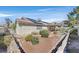 Property featuring a private backyard with desert landscaping and a covered patio at 6151 Naha Port Ave, Las Vegas, NV 89110