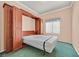 Bedroom with custom wood Murphy bed and green carpet at 6151 Naha Port Ave, Las Vegas, NV 89110
