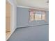 Cozy bedroom with blue walls, carpet and window. Bathroom access is visible to the left at 6151 Naha Port Ave, Las Vegas, NV 89110