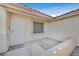 Welcoming front entrance featuring a security door, tiled porch, and well-maintained landscaping at 6151 Naha Port Ave, Las Vegas, NV 89110