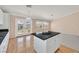 Bright kitchen features white cabinets, black granite countertops, island and backyard access at 6151 Naha Port Ave, Las Vegas, NV 89110