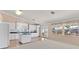 Open kitchen area features white cabinetry, granite countertops, and windows offering natural light at 6151 Naha Port Ave, Las Vegas, NV 89110