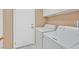 Functional laundry room featuring a washer, dryer, and ample storage cabinets at 6151 Naha Port Ave, Las Vegas, NV 89110