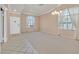 Bright living room featuring neutral paint, large windows, and tiled entry perfect for entertaining at 6151 Naha Port Ave, Las Vegas, NV 89110