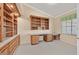Home office featuring built-in wooden shelving and desk space perfect for remote work or studying at 6151 Naha Port Ave, Las Vegas, NV 89110