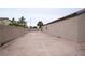 Large backyard featuring an extended concrete patio and mature landscaping at 6440 N Bruce St, North Las Vegas, NV 89086