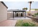 Covered patio and landscaped backyard with mature palm trees for shade at 6440 N Bruce St, North Las Vegas, NV 89086