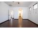 Bedroom with wood-look floors, ceiling fan, and access to the walk-in closet and hallway at 6440 N Bruce St, North Las Vegas, NV 89086