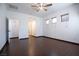 Bedroom features wood-look floors, a ceiling fan, and access to a walk-in closet and hallway at 6440 N Bruce St, North Las Vegas, NV 89086