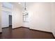 This dining area has wood-look flooring, a modern chandelier, and a window with stylish blinds at 6440 N Bruce St, North Las Vegas, NV 89086