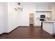 A spacious dining room shows sleek wood floors next to the kitchen with white cabinets and countertops at 6440 N Bruce St, North Las Vegas, NV 89086