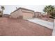 Charming home with a two-car garage and low-maintenance desert landscaping at 6440 N Bruce St, North Las Vegas, NV 89086