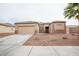 Charming single-story home featuring a neutral stucco exterior, a two-car garage, and low-maintenance desert landscaping at 6440 N Bruce St, North Las Vegas, NV 89086
