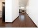 A long hallway features stylish wood floors and leads to an open living area with a fireplace and built-in shelves at 6440 N Bruce St, North Las Vegas, NV 89086