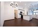 Bright kitchen featuring white cabinets, black appliances, and wood flooring at 6440 N Bruce St, North Las Vegas, NV 89086
