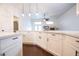 Modern kitchen with white cabinets, dark hardware, and dark wood flooring at 6440 N Bruce St, North Las Vegas, NV 89086