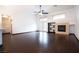 Bright living room with hardwood floors, ceiling fan, fireplace, and shelving at 6440 N Bruce St, North Las Vegas, NV 89086