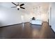 Open living space showcases dark, wood-look flooring and connects to the kitchen and other rooms at 6440 N Bruce St, North Las Vegas, NV 89086