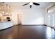 Open floor plan shows the living room leading into kitchen, with high ceilings, fan, and sliding glass doors at 6440 N Bruce St, North Las Vegas, NV 89086