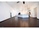 This living room features dark, wood-look tile flooring and an open floorplan to the kitchen at 6440 N Bruce St, North Las Vegas, NV 89086