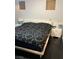 Stylish bedroom with a white padded headboard and matching nightstands with black bedside lamps at 7139 S Durango Dr # 218, Las Vegas, NV 89113
