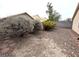 Desert landscaped backyard featuring rocks, various bushes, and flagstone path around the perimeter at 7209 London Bridge Ave, Las Vegas, NV 89130
