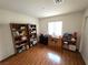 Bedroom with hardwood floors, shelves, a desk, and natural light at 7209 London Bridge Ave, Las Vegas, NV 89130