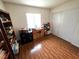 Bedroom featuring wooden floors, desk, shelves, natural light, and closet at 7209 London Bridge Ave, Las Vegas, NV 89130