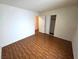 Spacious bedroom featuring wood floors, closet space, and a doorway to another room at 7209 London Bridge Ave, Las Vegas, NV 89130
