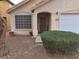 Welcoming home entrance with security door, manicured shrubbery, and desert landscaping for easy maintenance at 7209 London Bridge Ave, Las Vegas, NV 89130