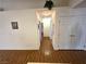 Bright hallway leading to various rooms, accentuated by wood floors and clean white walls at 7209 London Bridge Ave, Las Vegas, NV 89130