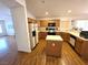 Bright kitchen featuring wood cabinets, white appliances, ample counter space, and a functional island at 7209 London Bridge Ave, Las Vegas, NV 89130