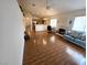 Open living room featuring wood floors, vaulted ceilings, a ceiling fan, and a fireplace at 7209 London Bridge Ave, Las Vegas, NV 89130